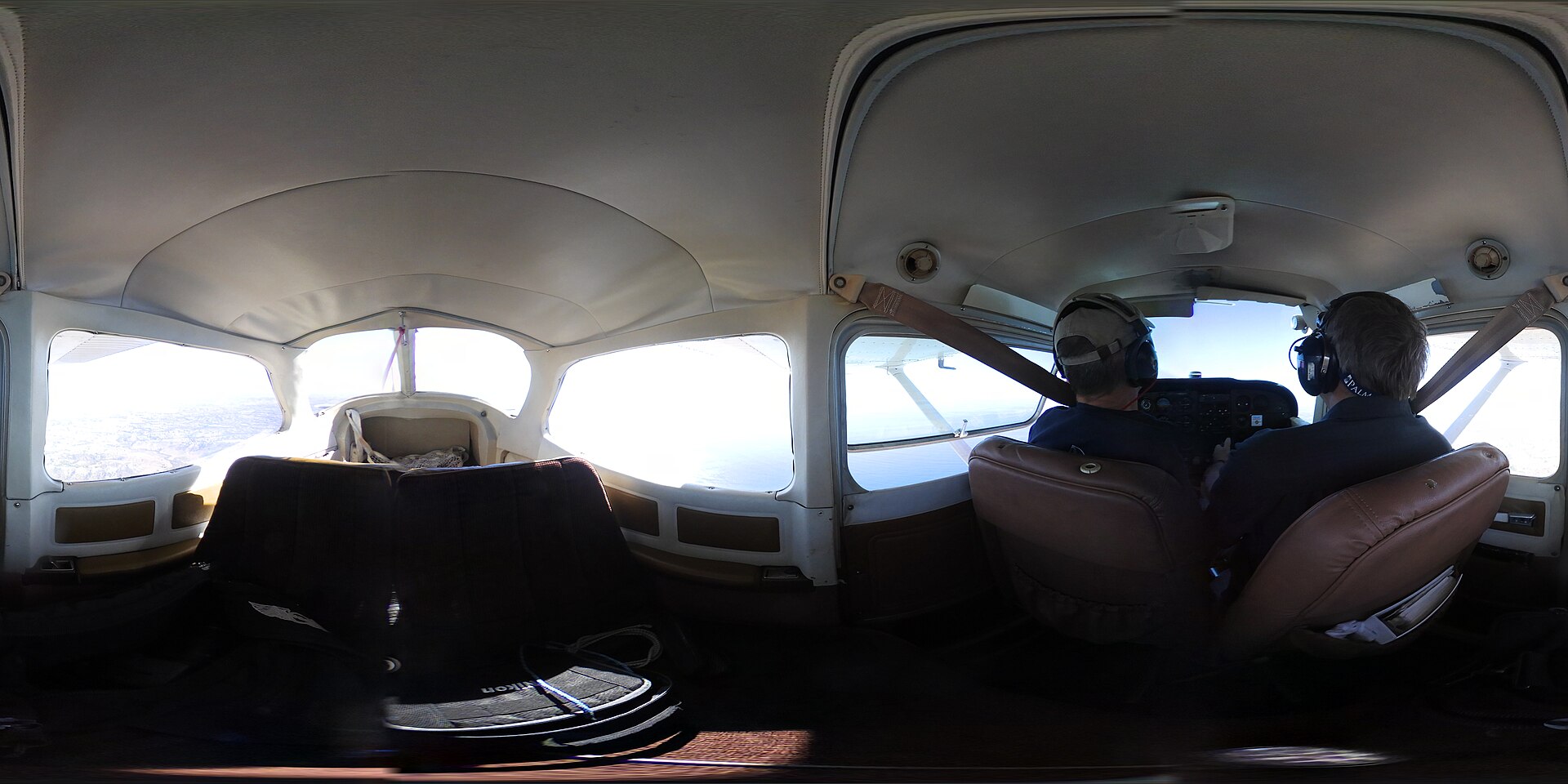 Cessna 172 in flight above the clouds